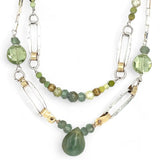 A double chain necklace with handmade hammered sterling silver rectangles and brass rings and straps, with green amethyst, green kyanite, crystal, cubic zirconia, and african metal beads