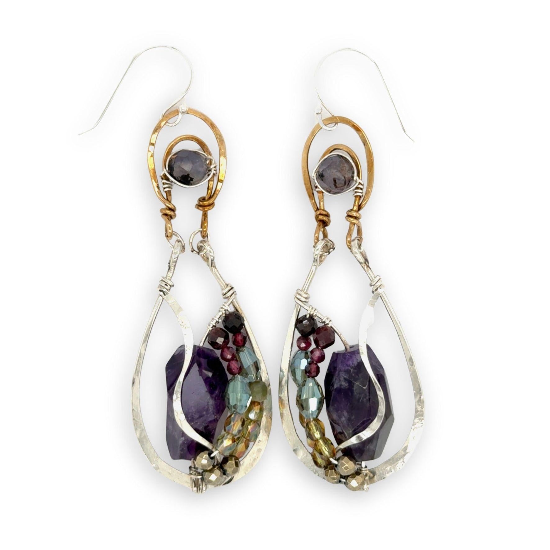 Dark amethyst nuggets are lined with pyrite, crystal, and garnet gemstones in sterling silver wire within sterling silver drops, hanging from bronze channel tops with iolite gemstones