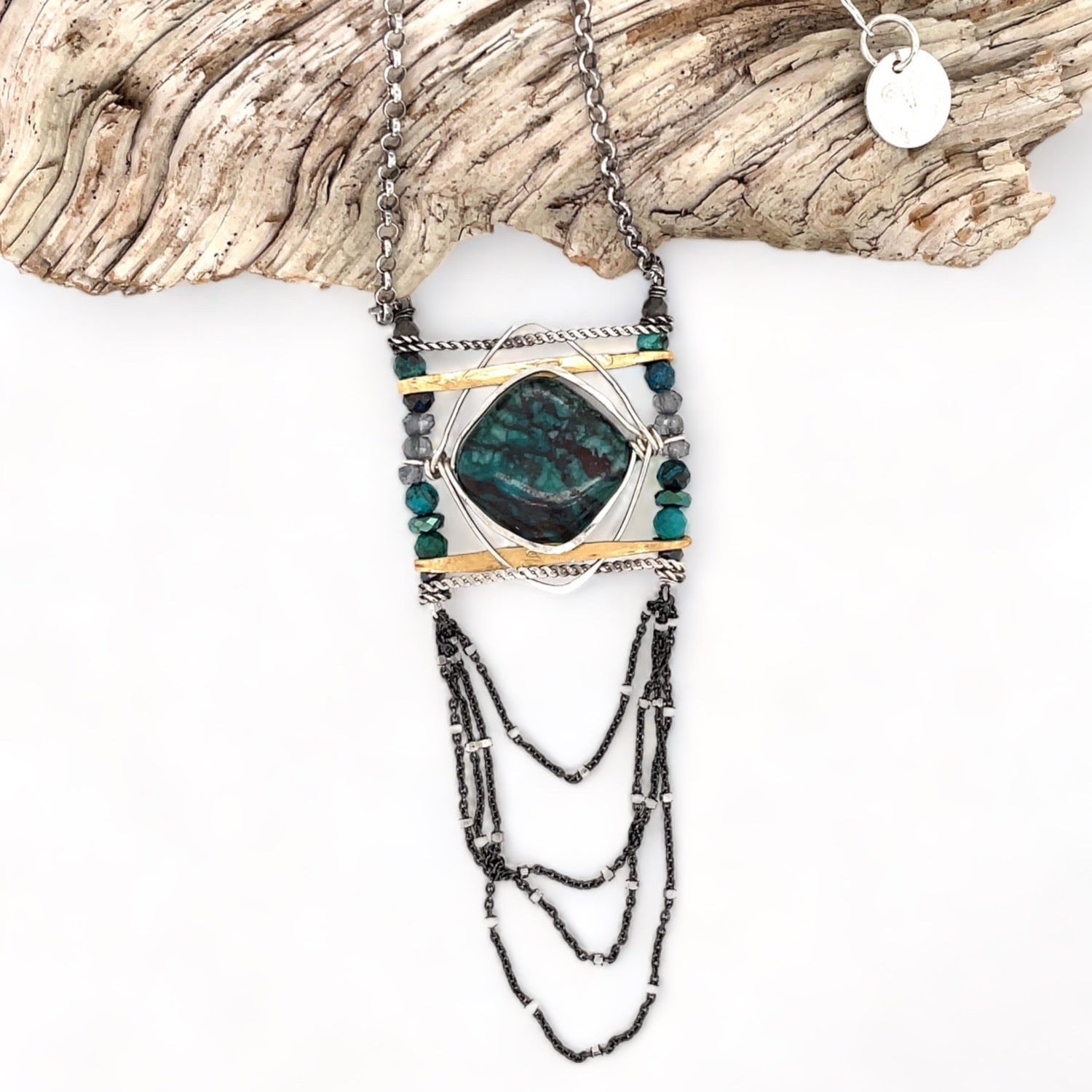 Turquoise tile held within layers of sterling silver wire suspended between lines of brass and oxidized sterling silver twist bars. Side pieces include blue quartz, chrysocolla, and pyrite gemstones, Oxidized sterling silver satellite dot chain chandelier bottom
