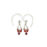 Tiny hammered sterling silver teardrops with red cubic zirconia hang from our handmade sterling silver hoop earrings