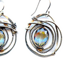 A pair of sterling silver earrings featuring a hammered design with a central blue crystal, edged with oxidized sterling silver twist wirev