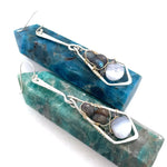 A pair of sterling silver arrow earrings featuring blue lace agate drops and flashy labradorite gemstones, set in gold-filled.