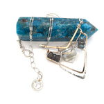 A brass and sterling silver pendant necklace featuring a blue lace agate point and faceted flashy labradorite gemstones with a doubled sterling silver sparkly chain