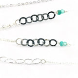A mini sterling silver drop pendant with amazonite and pyrite gemstones in gold filled wire on a dainty sterling silver chain with oxidized sterling crinkle chain accent necklace
