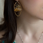 Citrine nuggets held in a bronze marquise earring frame accompanied by gold filled wire, rutilated quartz gemstones, and gold filled satellite chain
