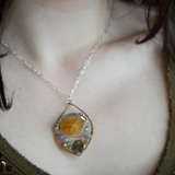 Citrine nugget surrounded by labradorite gemstones and crystal inside a hammered handmade bronze drop necklace with sterling silver and brass twist wire accents