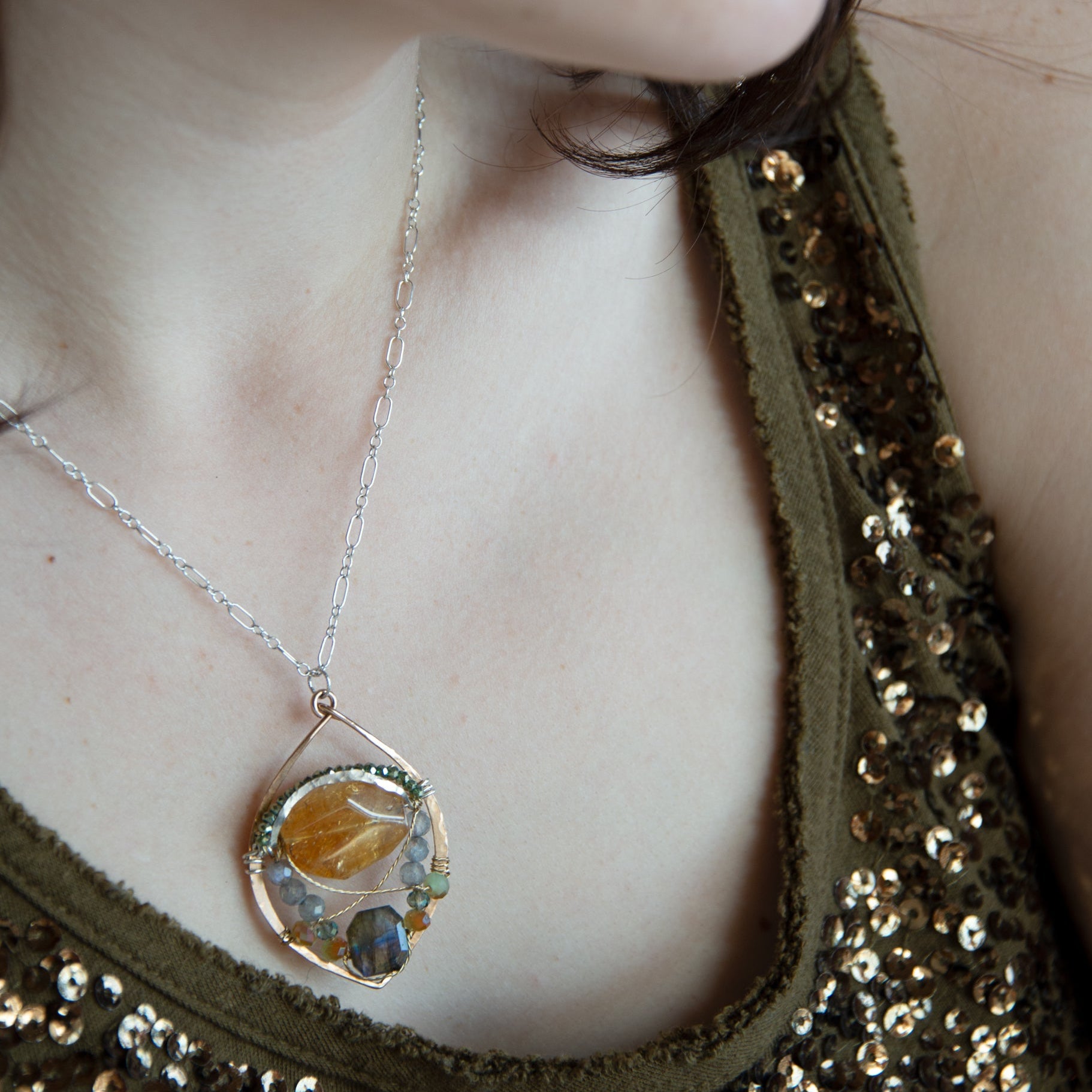 Citrine nugget surrounded by labradorite gemstones and crystal inside a hammered handmade bronze drop necklace with sterling silver and brass twist wire accents