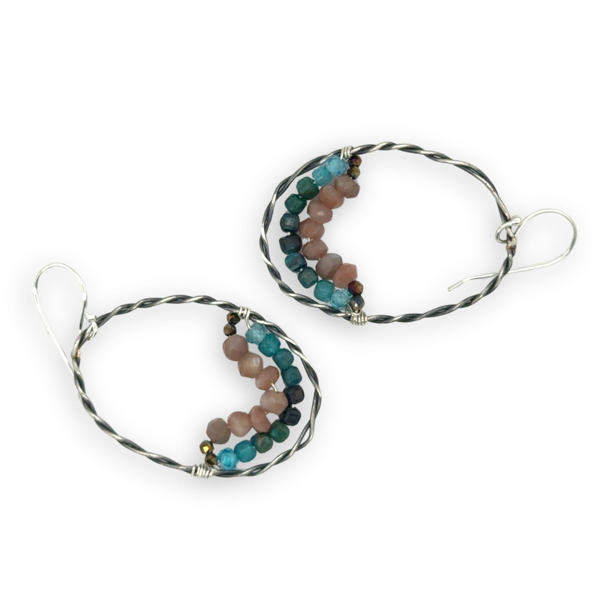 darkened sterling silver twisted hoop earrings with pyrite, mauve moonstone, and chrysocolla faceted gemstones