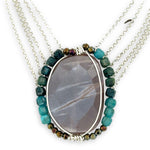 Mauve moonstone nugget pendant surrounded by pyrite and chrysocolla cube gemstones with multi layered chain webbing necklace
