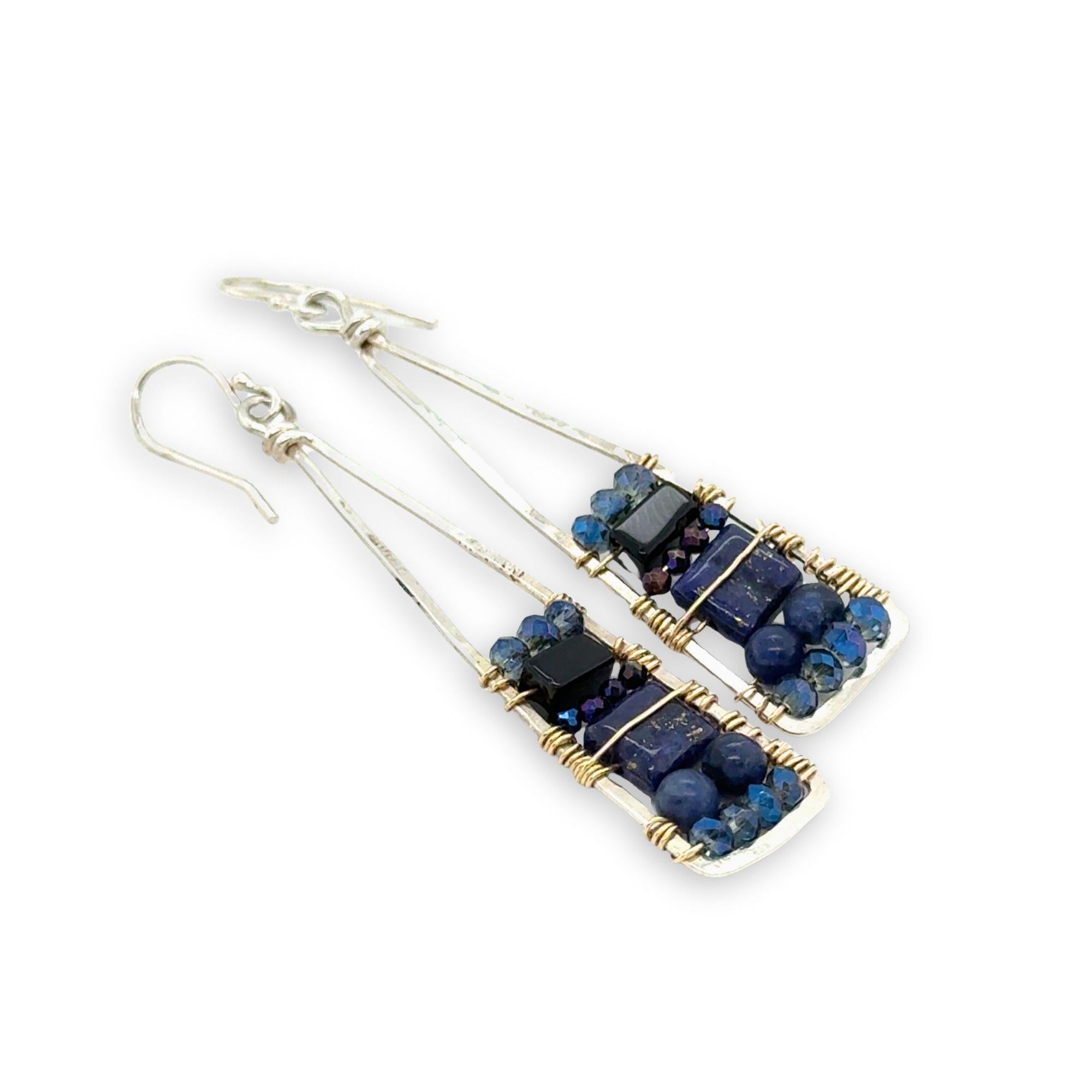 Lapis and onyx gemstones stacked with blue crystal on gold filled wire within a skinny, tall sterling silver triangle shaped earrings