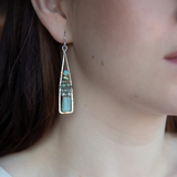 Terra verde smooth oval gemstones layered with light blue fresh water pearl, crystal, and amazonite gemstones on gold filled wire within skinny triangle shaped earrings