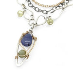Sterling silver stamped mini drop necklace with smooth tanzanite drop and green kyanite gemstones on a triple strand gold filled. darkened sterling, and handmade sterling link chain