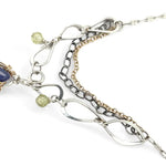 Sterling silver stamped mini drop necklace with smooth tanzanite drop and green kyanite gemstones on a triple strand gold filled. darkened sterling, and handmade sterling link chain