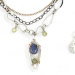 Sterling silver stamped mini drop necklace with smooth tanzanite drop and green kyanite gemstones on a triple strand gold filled. darkened sterling, and handmade sterling link chain