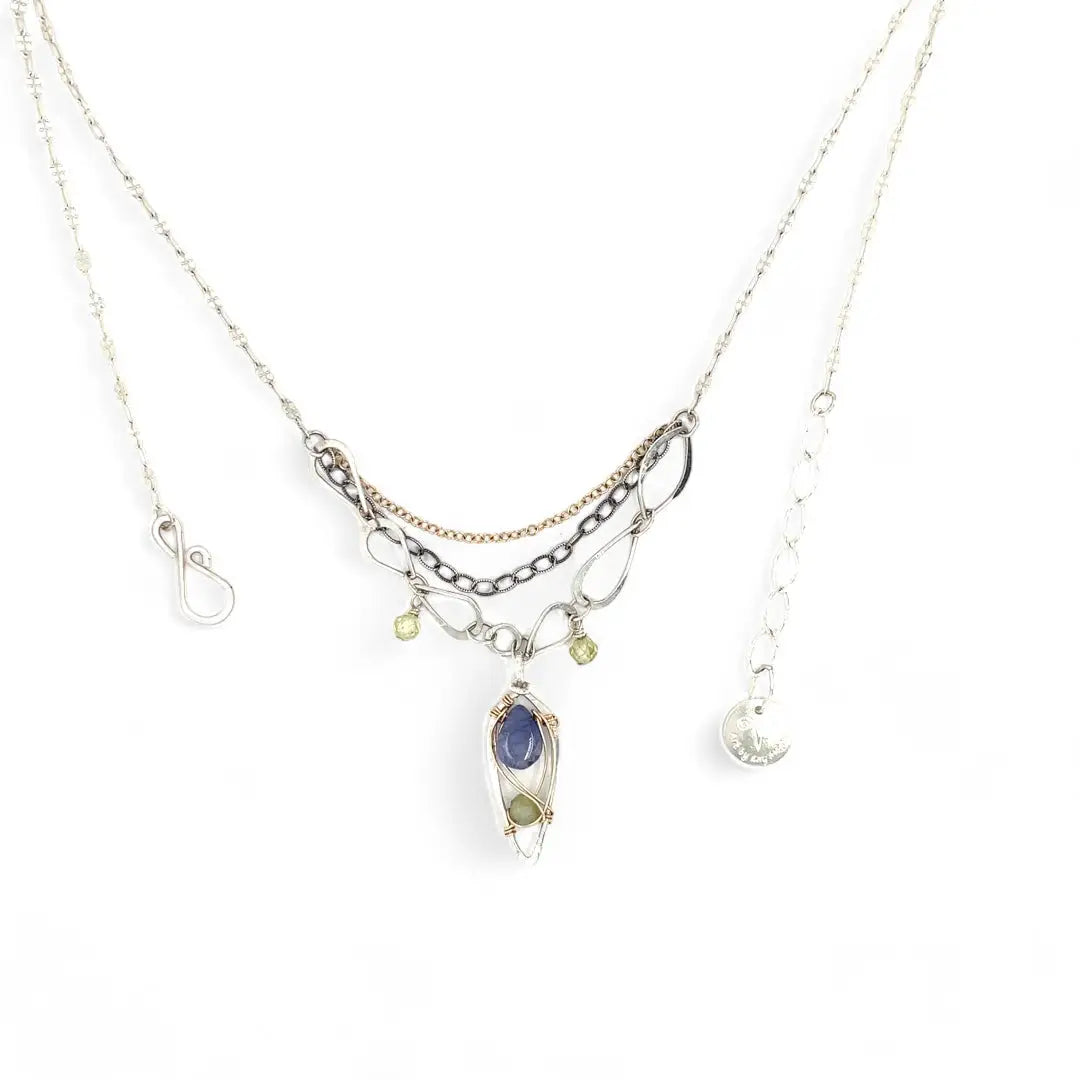 Sterling silver stamped mini drop necklace with smooth tanzanite drop and green kyanite gemstones on a triple strand gold filled. darkened sterling, and handmade sterling link chain