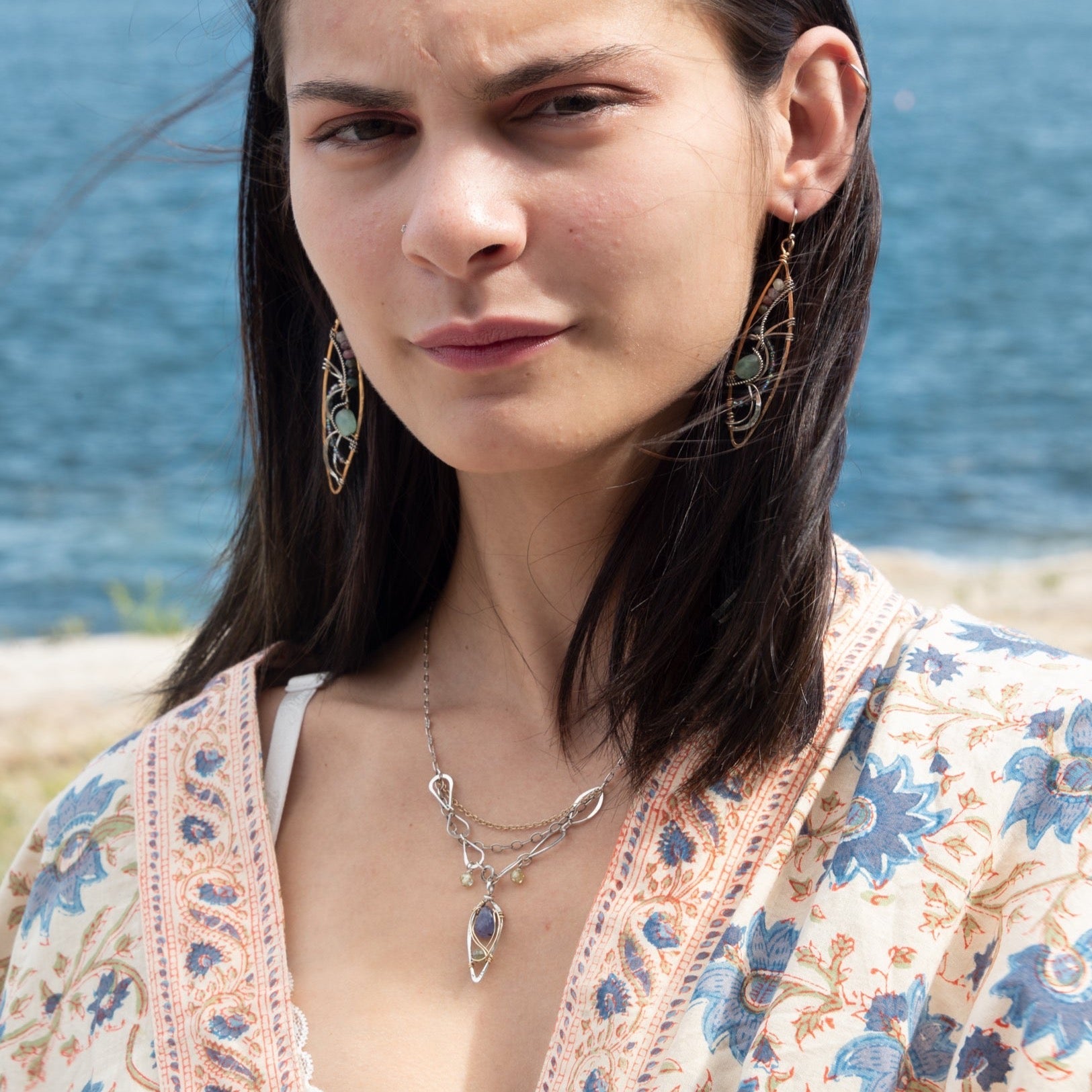 Sterling silver stamped mini drop necklace with smooth tanzanite drop and green kyanite gemstones on a triple strand gold filled. darkened sterling, and handmade sterling link chain
