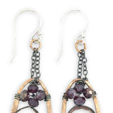 hammered bronze oval earrings with moonstone and garnet faceted gemstones in oxidized sterling silver wire hanging from oxidized sterling delicate chain