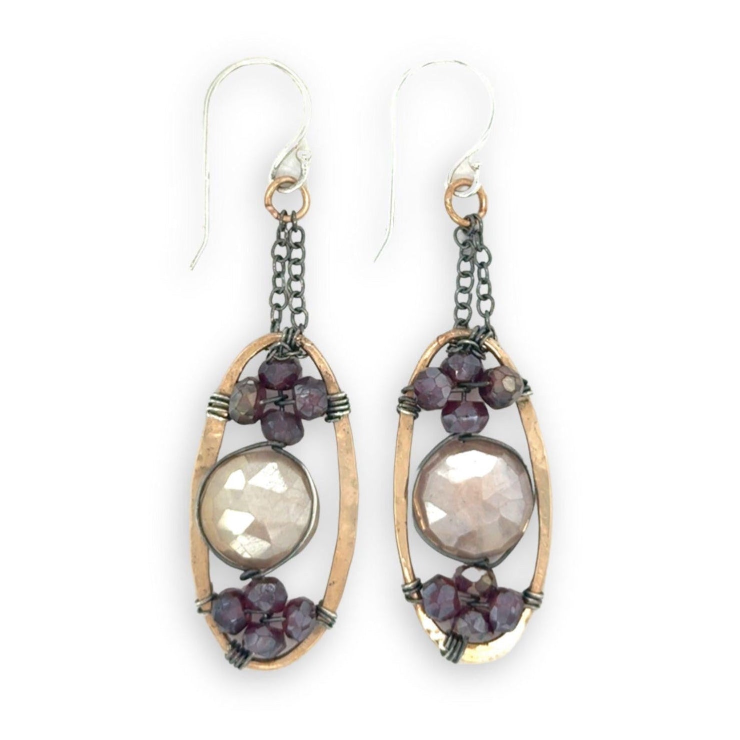 hammered bronze oval earrings with moonstone and garnet faceted gemstones in oxidized sterling silver wire hanging from oxidized sterling delicate chain