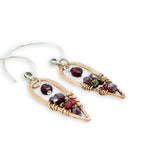 mini bronze teardrops filled with garnet and pyrite gemstones hanging from our handmade sterling silver hoop earrings