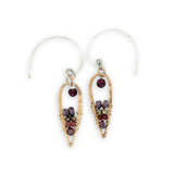 mini bronze teardrops filled with garnet and pyrite gemstones hanging from our handmade sterling silver hoop earrings