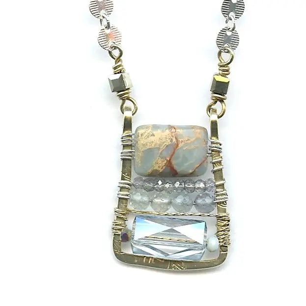 crystal, apatite, blue quartz, and terra verde jasper gemstones stacked on top of each other in a brass box mini pendant necklace on sterling silver delicate chain