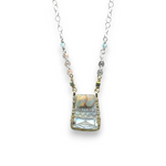 crystal, apatite, blue quartz, and terra verde jasper gemstones stacked on top of each other in a brass box mini pendant necklace on sterling silver delicate chain