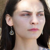 Sterling silver leaf stamped drop earrings with green kyanite gemstones and purple crystal drops wrapped in hammered brass wire, on sterling silver bar chain