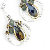 Sterling silver leaf stamped drop earrings with green kyanite gemstones and purple crystal drops wrapped in hammered brass wire, on sterling silver bar chain
