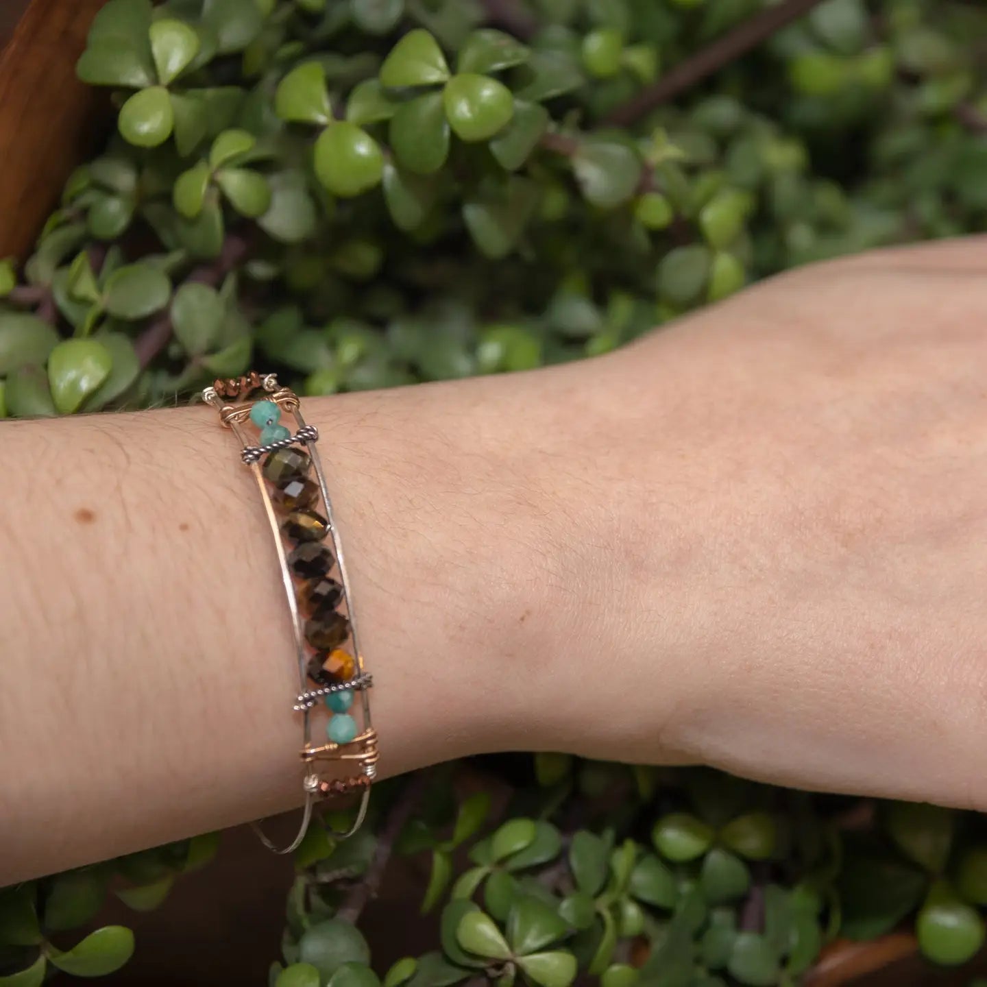 Skinny sterling silver hammered bracelet with faceted tiger's eye, amazonite, and pyrite gemstones, featuring darkened sterling silver twist and bronze hammered accents