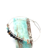 Skinny sterling silver hammered bracelet with faceted tiger's eye, amazonite, and pyrite gemstones, featuring darkened sterling silver twist and bronze hammered accents