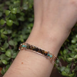 Skinny sterling silver hammered bracelet with faceted tiger's eye, amazonite, and pyrite gemstones, featuring darkened sterling silver twist and bronze hammered accents