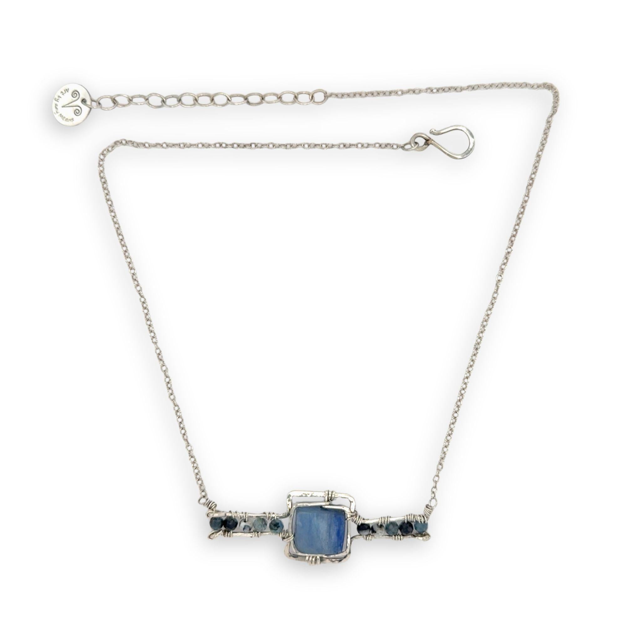 blue kyanite tile held between sterling silver fish tin shape necklace accented with aquamarine faceted gemstones