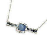 blue kyanite tile held between sterling silver fish tin shape necklace accented with aquamarine faceted gemstones