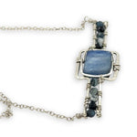 blue kyanite tile held between sterling silver fish tin shape necklace accented with aquamarine faceted gemstones