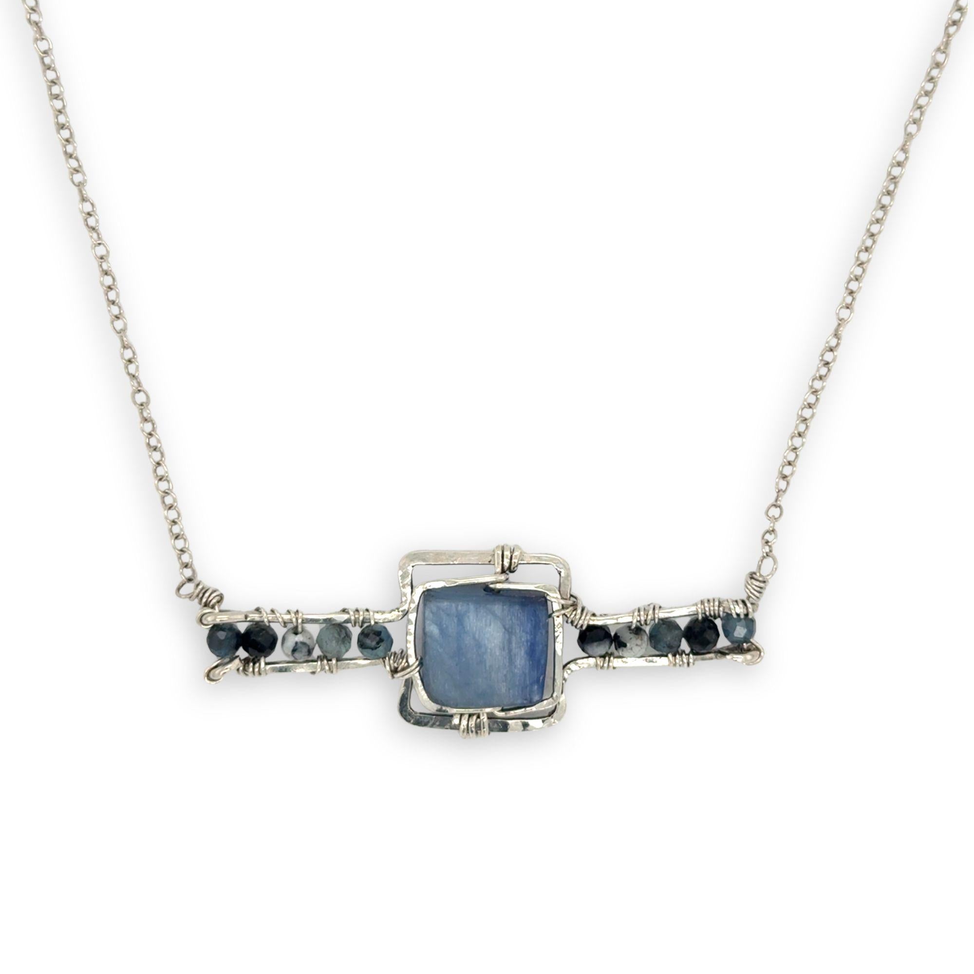 blue kyanite tile held between sterling silver fish tin shape necklace accented with aquamarine faceted gemstones