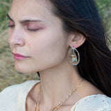 A pair of sterling silver and bronze hammered earrings with smooth prehnite coin and watermelon tourmaline gemstones, with built in earring hooks to wear like a post earring.