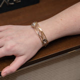 champagne colored faceted crystals held in braided layers of sterling silver, bronze and twisted brass hammered wires all inside a bronze cuff handmade bracelet