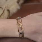 champagne colored faceted crystals held in braided layers of sterling silver, bronze and twisted brass hammered wires all inside a bronze cuff handmade bracelet