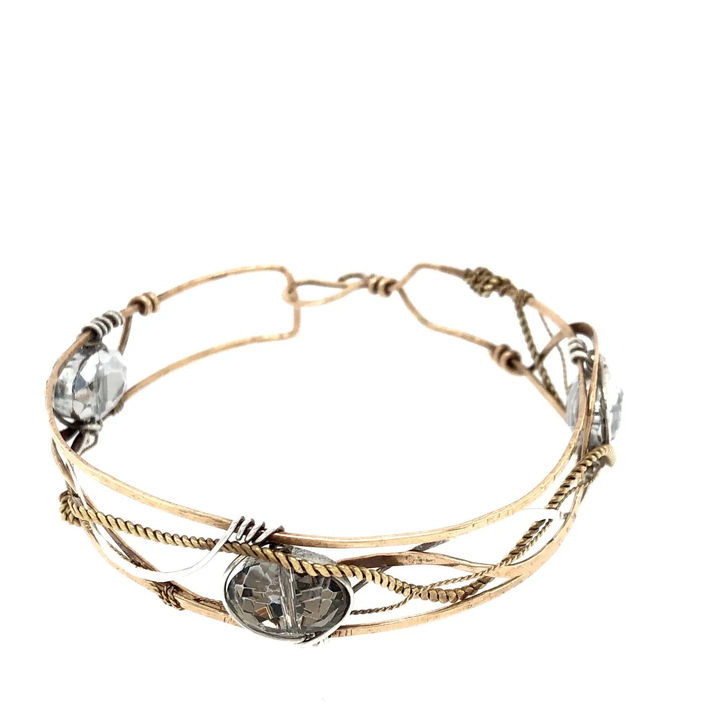 champagne colored faceted crystals held in braided layers of sterling silver, bronze and twisted brass hammered wires all inside a bronze cuff handmade bracelet