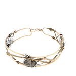 champagne colored faceted crystals held in braided layers of sterling silver, bronze and twisted brass hammered wires all inside a bronze cuff handmade bracelet
