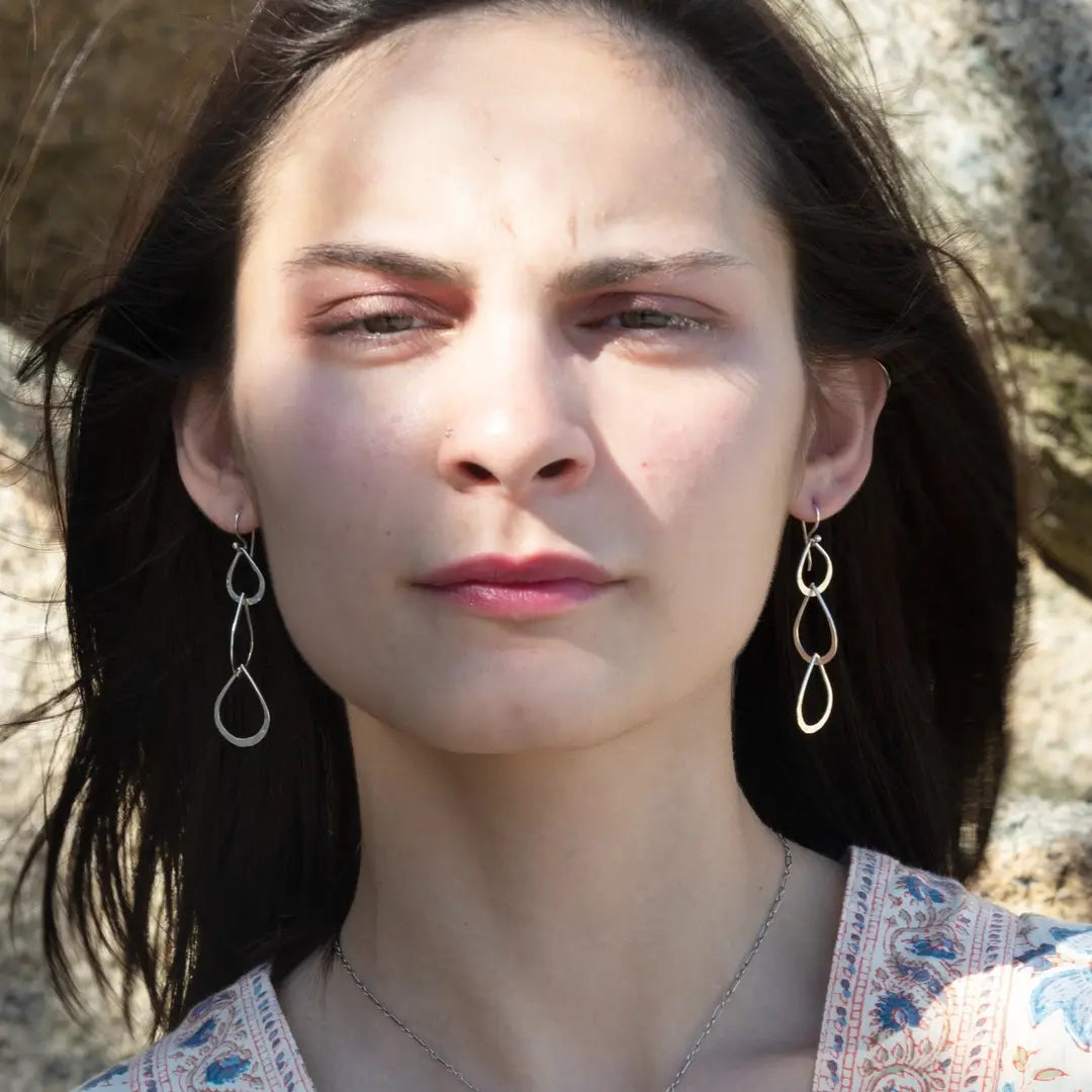 Triple handmade hammered sterling silver teardrops interlocked within each other to make a long earring