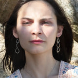 Triple handmade hammered sterling silver teardrops interlocked within each other to make a long earring