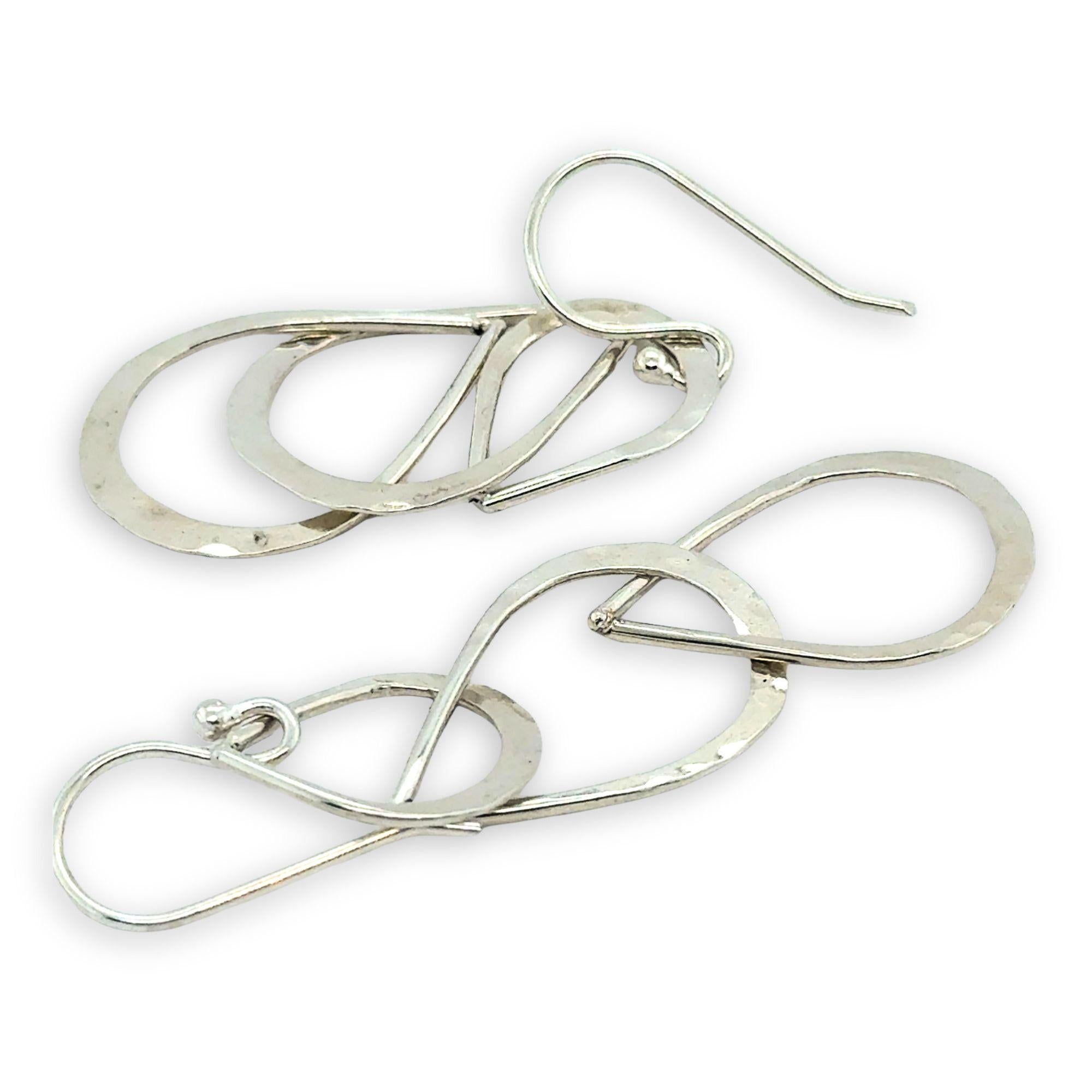 Triple handmade hammered sterling silver teardrops interlocked within each other to make a long earring