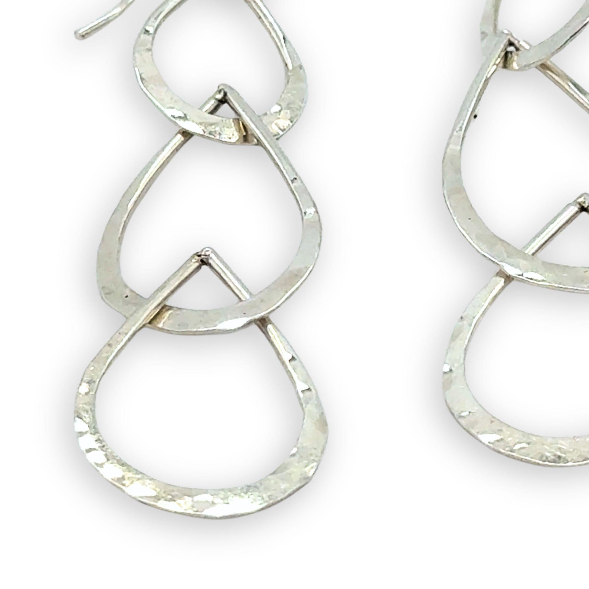 Triple handmade hammered sterling silver teardrops interlocked within each other to make a long earring