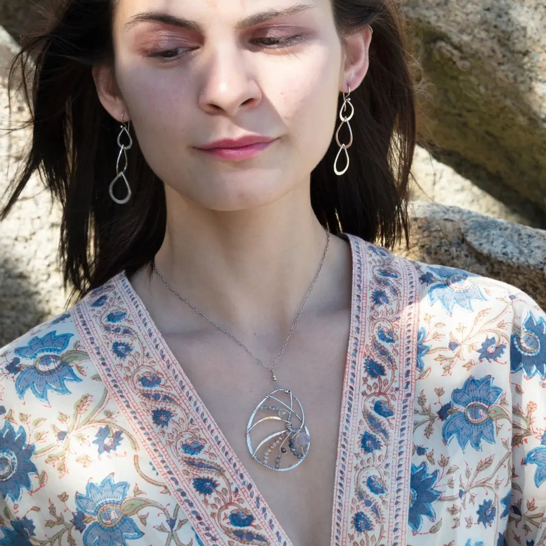 Triple handmade hammered sterling silver teardrops interlocked within each other to make a long earring