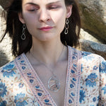 Triple handmade hammered sterling silver teardrops interlocked within each other to make a long earring