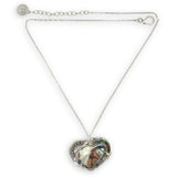 Necklace with a heart-shaped sterling silver hammered pendant featuring a gaspeite, turquoise, and pyrite gemstones