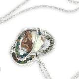 Necklace with a heart-shaped sterling silver hammered pendant featuring a gaspeite, turquoise, and pyrite gemstones