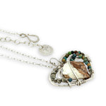 Necklace with a heart-shaped sterling silver hammered pendant featuring a gaspeite, turquoise, and pyrite gemstones