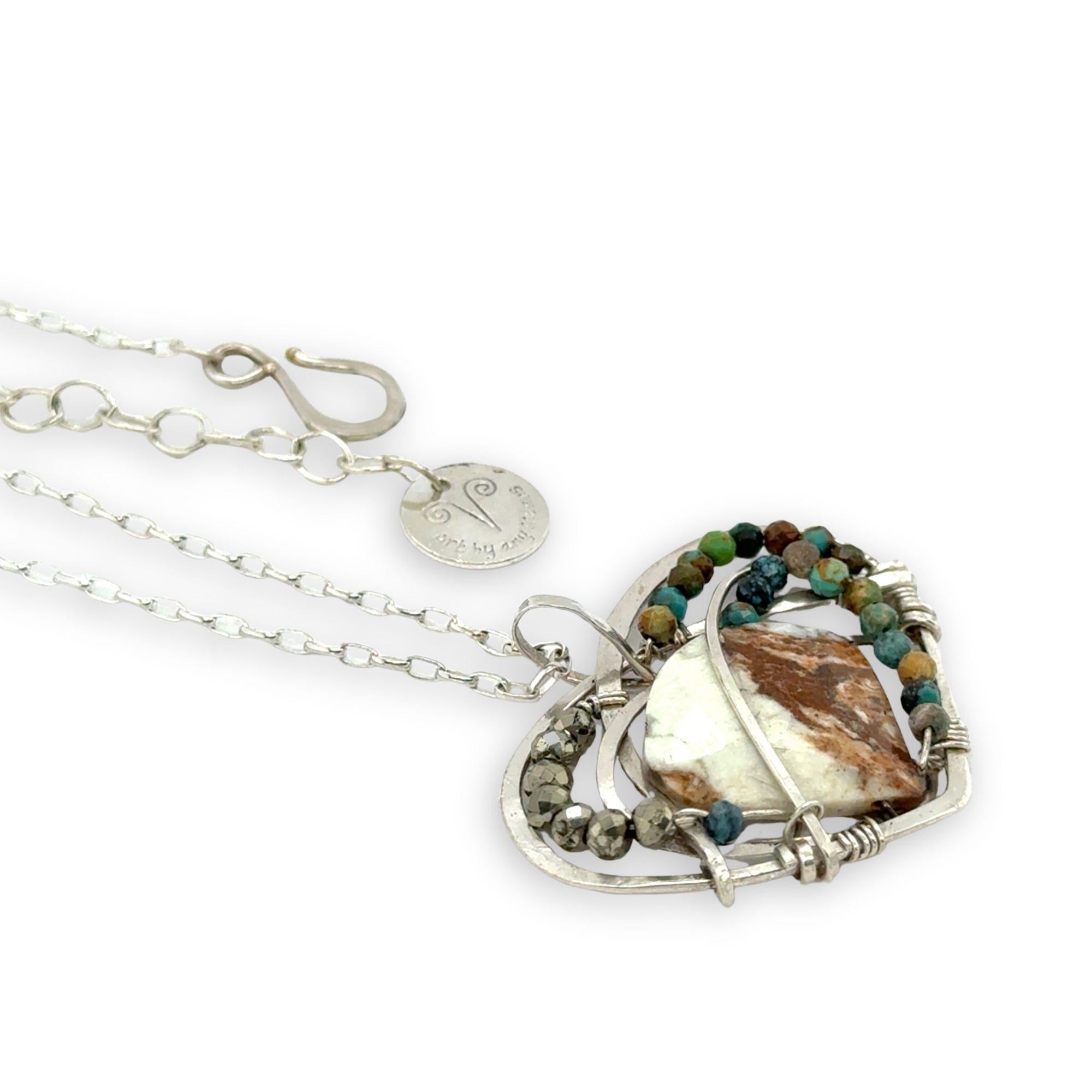 Necklace with a heart-shaped sterling silver hammered pendant featuring a gaspeite, turquoise, and pyrite gemstones